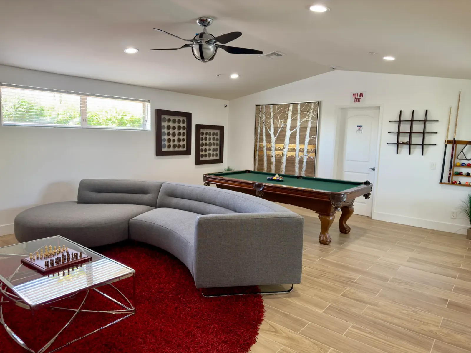 Common room with a sectional sofa and pool table at the Mental Wellness KS facility in Palm Springs